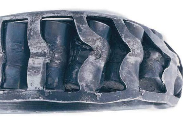 Fractured stamped steel cage in a cylindrical roller bearing caused by vibration and shock loads.