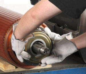 A technician installing the bearing on the motor and needs to avoid improper installation