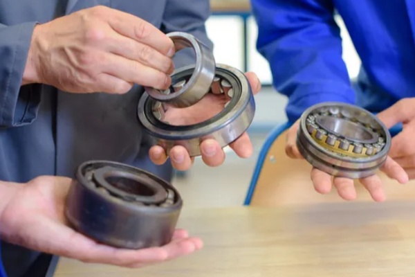 Engineers cross-referencing bearing part numbers and suffixes to ensure accurate direct replacement and interchangeability.