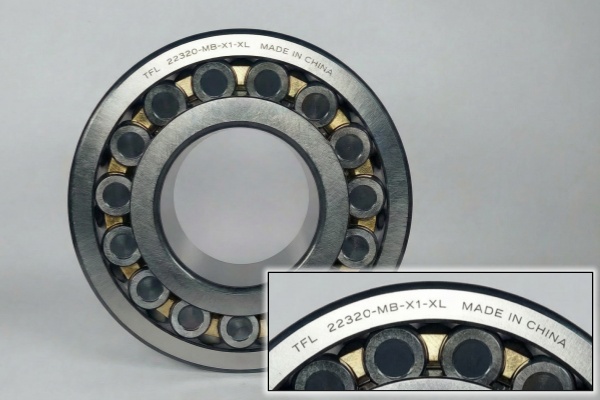 The TFL 22320MB/W33 C4 spherical roller bearing featuring a solid machined brass cage designed for high-vibration applications like road rollers.